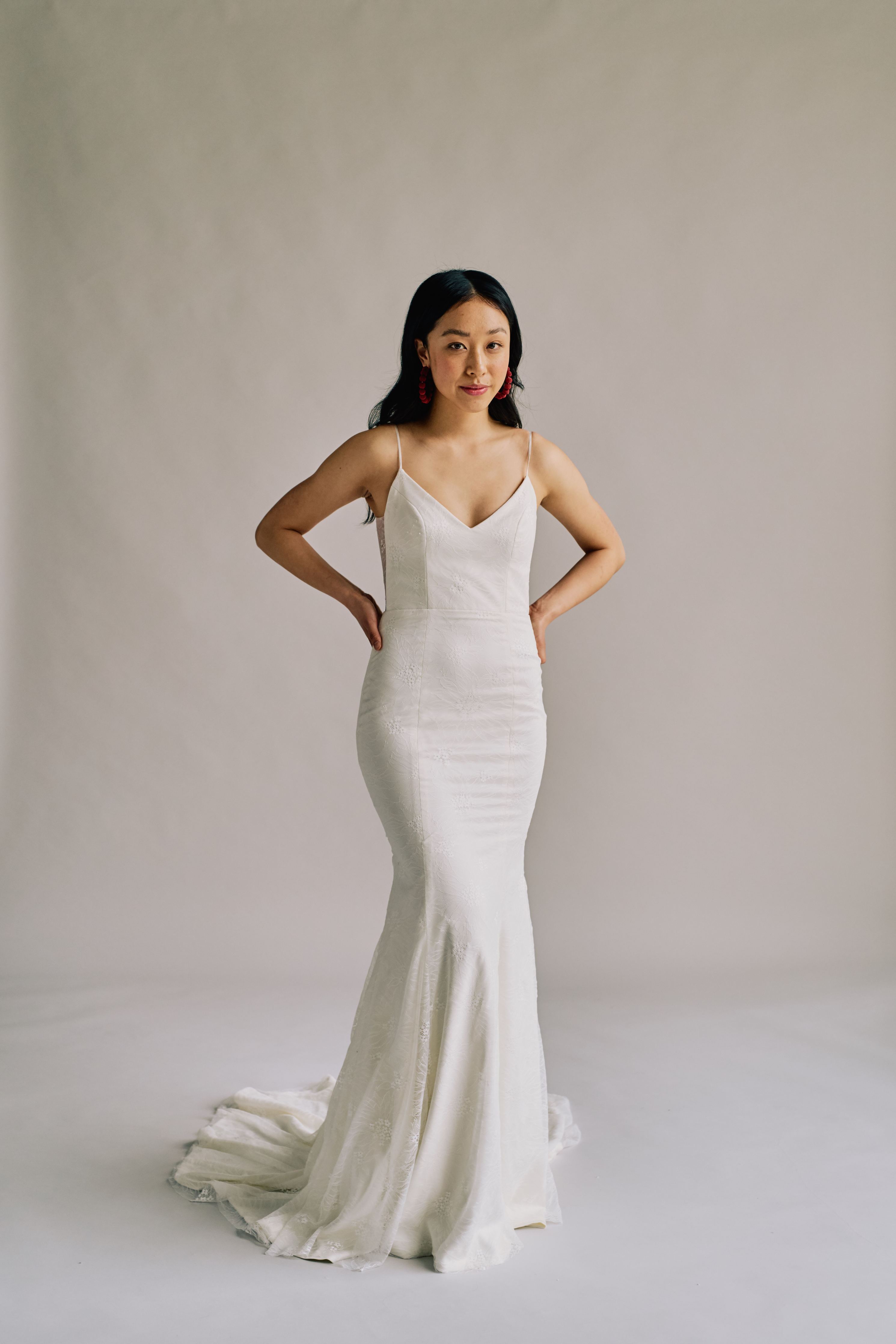 Form fitting wedding dress with a lightweight sunflower lace, a sheer open back, and a v neck.