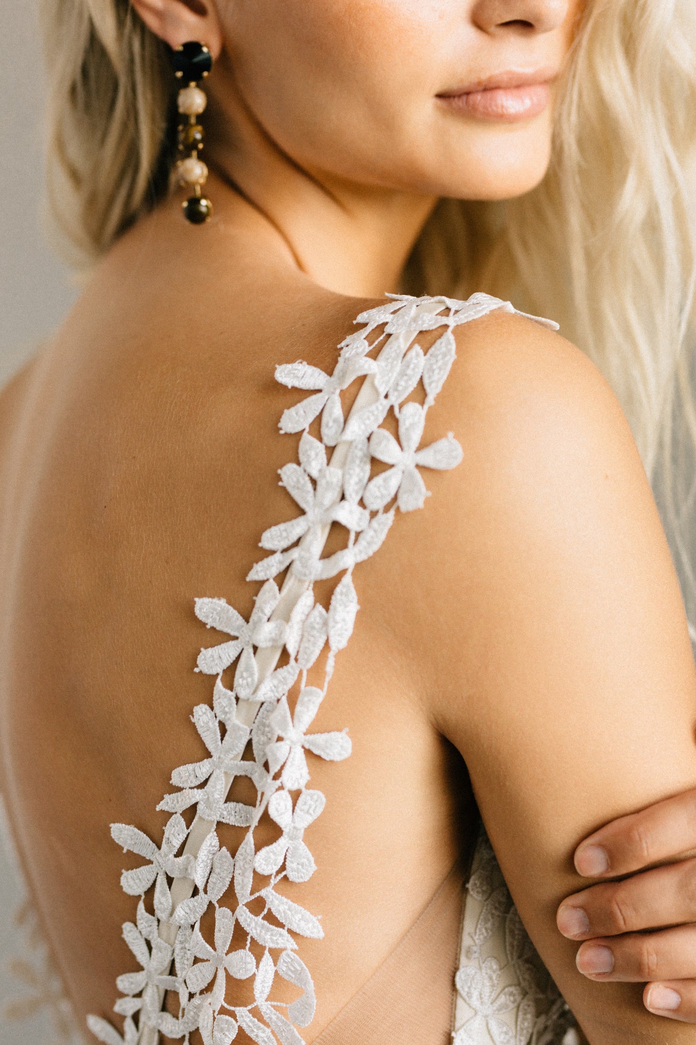 Daisy print lace wedding dress with a form-fitting shape, open back, and extra long train